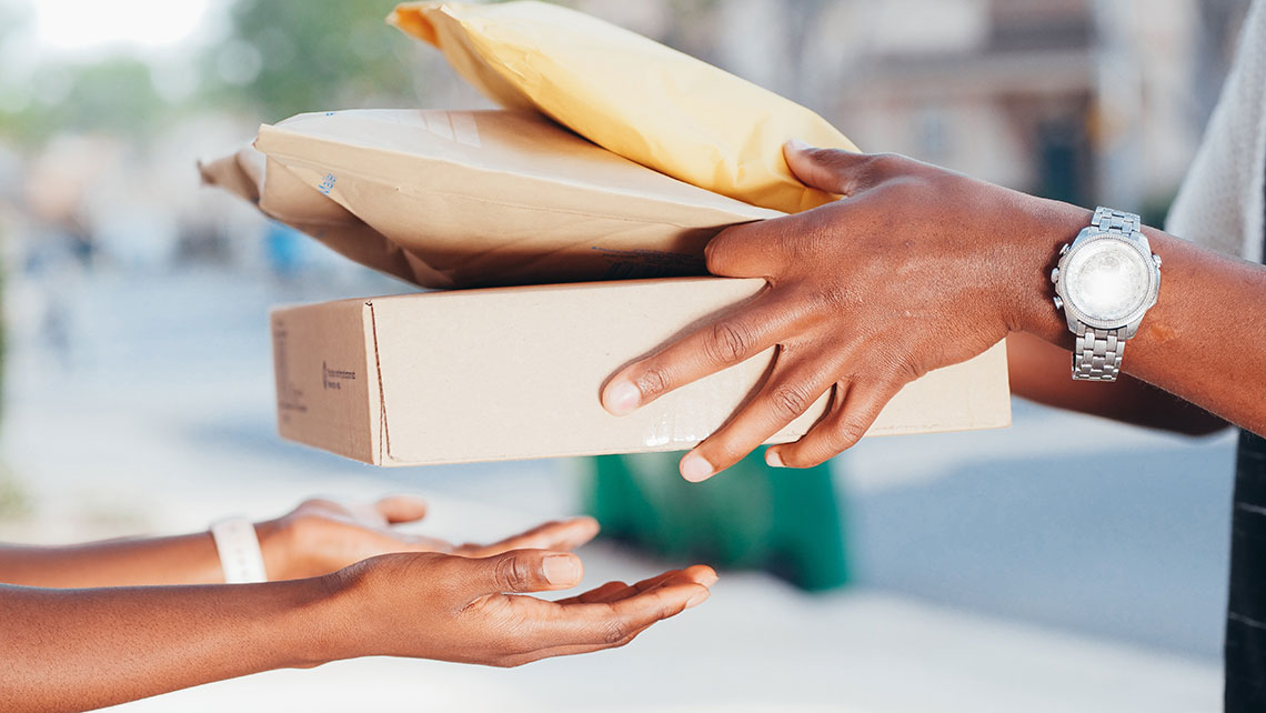 Three packages are safely delivered from the hands of a professional medical courier