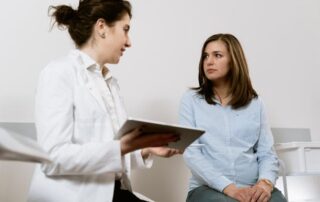 woman doctor attending female patient