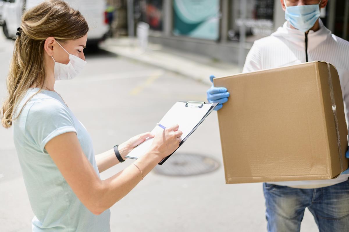 Woman signing for medical supply delivery Woman signing for medical supply delivery